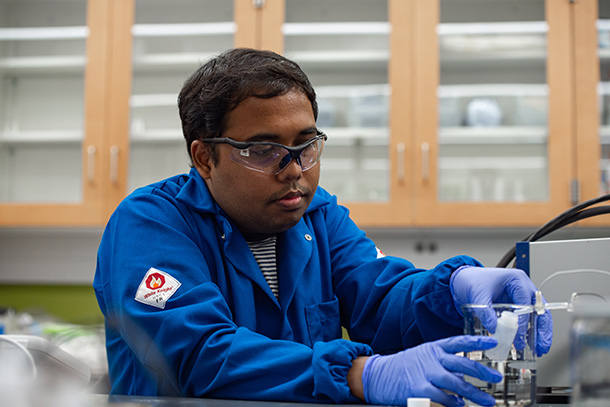 Mahmudul Hasan, a chemical engineering doctoral student, collects a purified water sample from the membrane capacitive deionization unit. Credit: Kelby Hochreither/Penn State. All Rights Reserved.