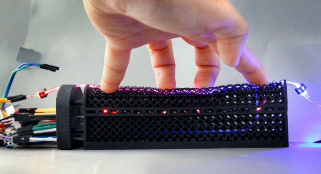 porous lattice structure is threaded with stretchable optical fibers containing more than a dozen mechanosensors and attached to an LED light. When the lattice structure is pressed