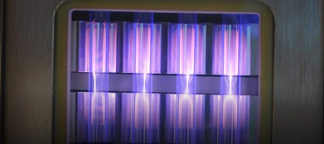 UV light being emitted by a krypton chloride excimer lamp, fueled by molecules moving between different states of energy. Courtesy: Linden Research Group, CU Boulder