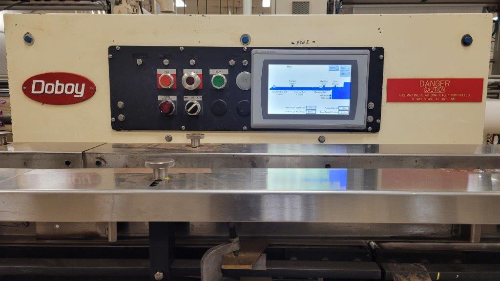 A picture of these new touchscreens installed where the former PLC was. The touchscreen provides much more functionality and control than the former controls.