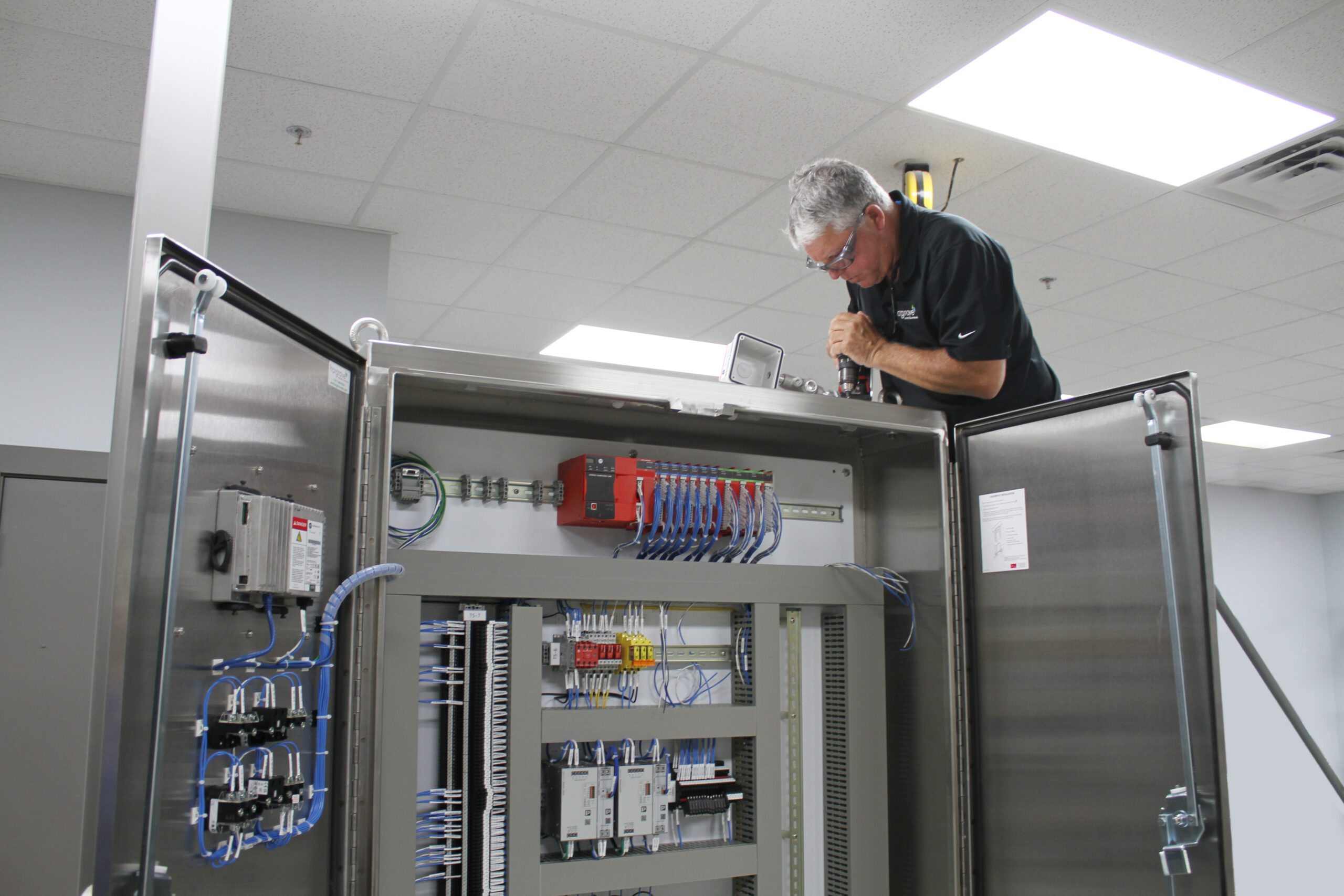 Figure 1: Panel shop technician installs a warning beacon and horn for a petrochemical client. Courtesy: Hargrove Controls & Automation