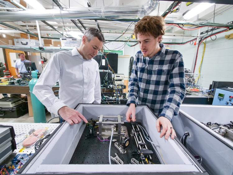 Greg Rieker (left) works with a colleague in the lab at CU Boulder. Courtesy: Colorado University.