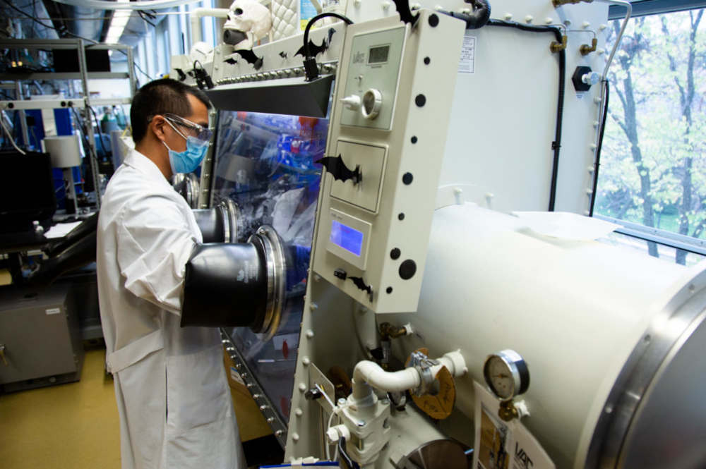 Michael Wang, materials science and engineering Ph.D. candidate, uses a glove box to inspect a lithium metal battery cell in a lab at the University of Michigan in 2020. Courtesy: University of Michigan