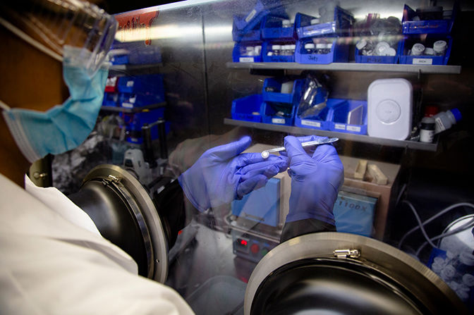 Michael Wang, materials science and engineering Ph.D. candidate, uses a glove box to inspect a lithium metal battery cell in a lab in the Michigan Memorial Phoenix Project building at the University of Michigan in Ann Arbor, Mich. on October 19, 2020. Courtesy: University of Michigan