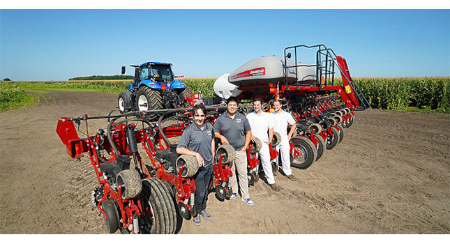 Agricultural tractors and implements use a lot of hydraulic power. By creating new solutions to optimize their hydraulic control systems, Purdue researchers (left to right) Andrea Vacca, Xiaofan Guo, Patrick Stump, and Jake Lengacher are working to make tractors more powerful and fuel-efficient. Courtesy: Purdue University/Jared Pike