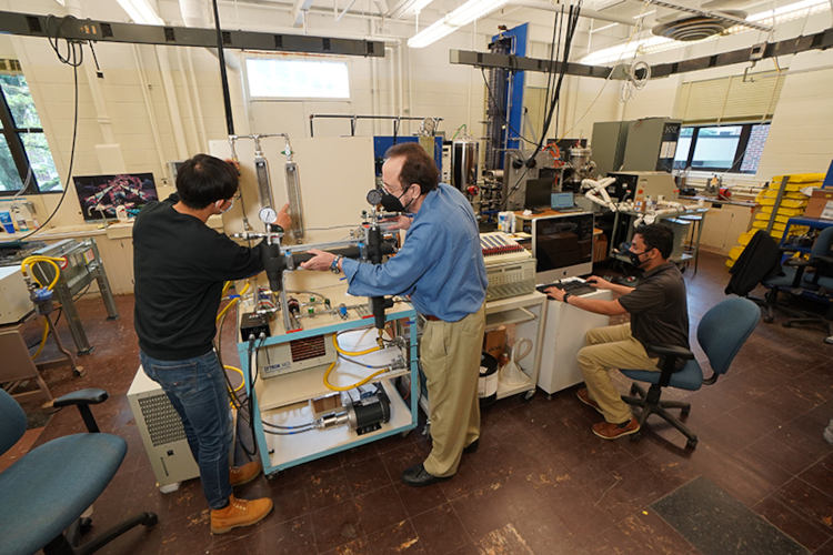 A new charging cable design developed by Purdue professor Issam Mudawar (center) and his students could reduce an electric vehicle’s charging time to under five minutes.