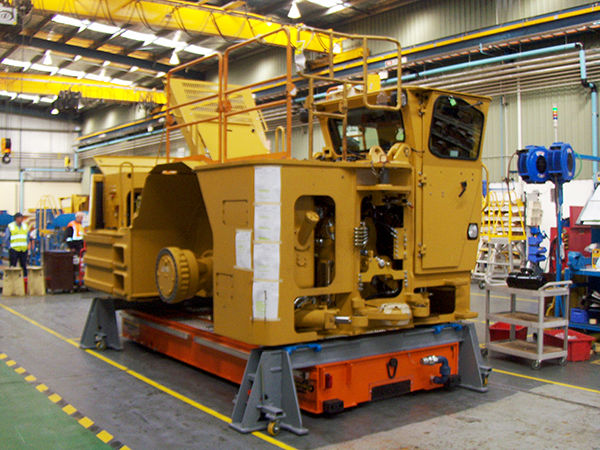 Two material handling options work in tandem here: an embedded air caster system moves a rebuild engine positioner below a crane.