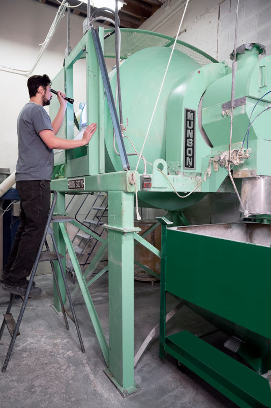 Clean-out doors allow unrestricted access to the mixer interior. The horizontal vessel rotates on external trunnion rings located at each end, with no internal shaft or bearings contacting material being.