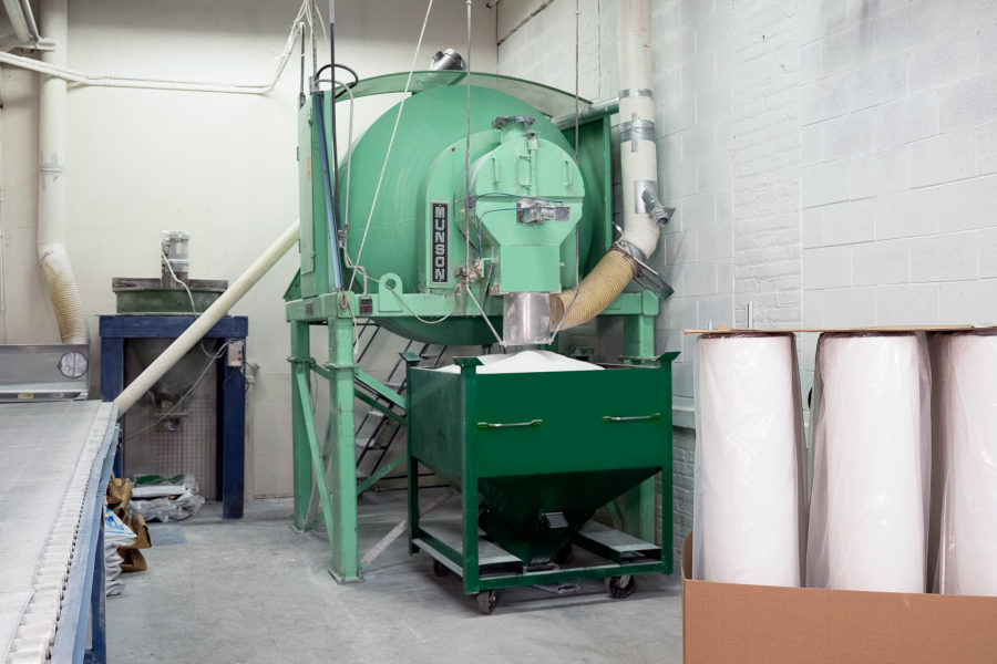 In the mixing room a rotary batch mixer distributes resins, waxes and fillers uniformly in 1,000 lb. batches.
