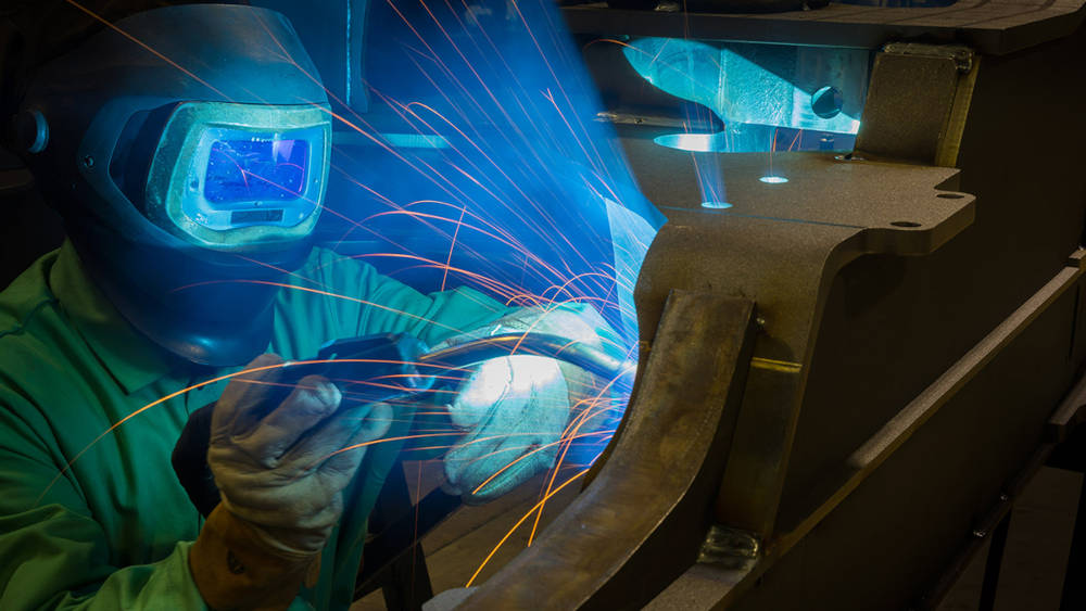 A welder at John Deere's Davenport Works facility in Davenport, Iowa. Courtesy: John Deere, Iowa State University