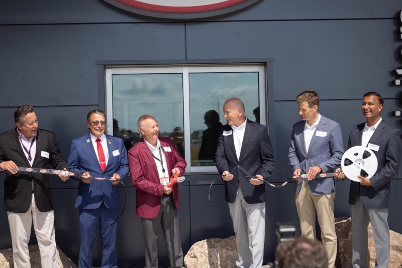 Digi-Key officially opened its Product Distribution Center expansion with a Digi-Reel cutting and ceremonial package handoffs. Pictured: Chris Lauer, vice president, order fulfillment, Digi-Key; Thief River Falls Mayor Brian Holmer; Dr. Ron Stordahl, owner, Digi-Key; Dave Doherty, president, Digi-Key; Minnesota Department of Employment and Economic Development Commissioner Steve Grove; and Ramesh Babu, CIO, Digi-Key.