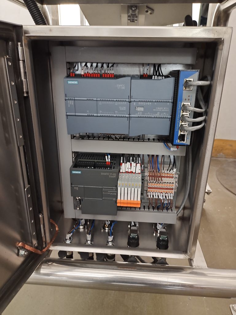 The control system for weighing and batching system. The modules are specially used for weighing batch control. A PLC is used for process recipe management and logic control of feeding and discharging equipment, allowing operators to modify and maintain on site. The two PLC are connected by PN communication. Courtesy: Siemens
