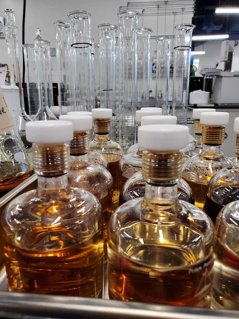 Figure 2: The foreground show special bottles used for corrosive sulfur testing. The background is graduated cylinders used in everyday lab activity. Courtesy: Doble Engineering