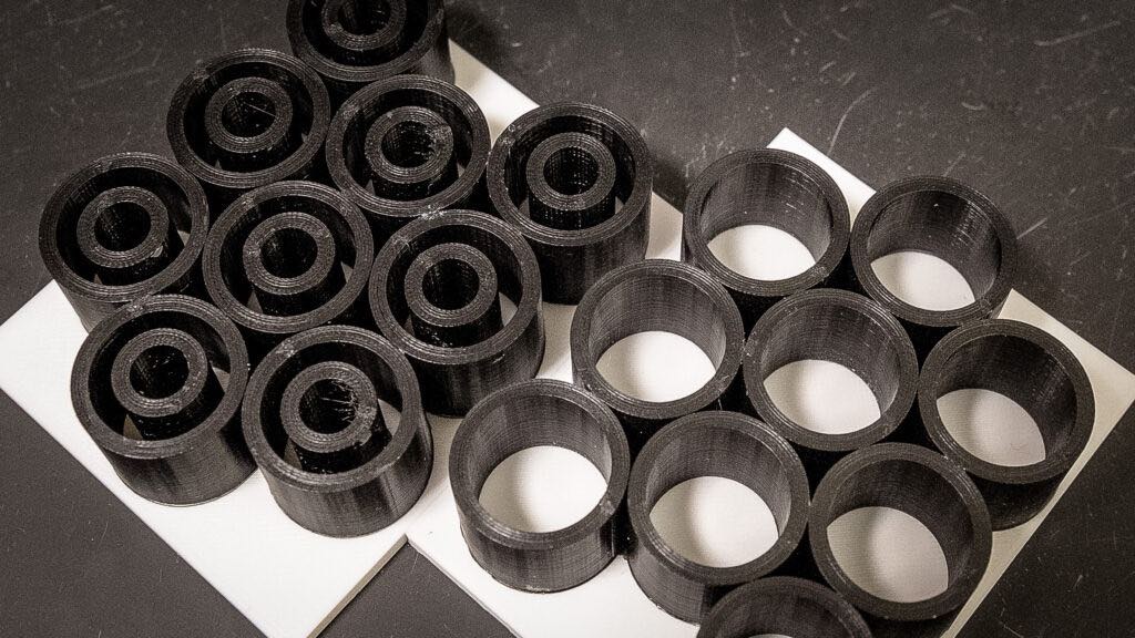 These displays show, at a much larger scale, the researchers’ architectures for their vertically aligned carbon nanotube foam. The display on the left depicts the architecture of closely packed thin concentric cylinder structures detailed in the ACS Nano paper. Courtesy: Joel Hallberg, UW-Madison