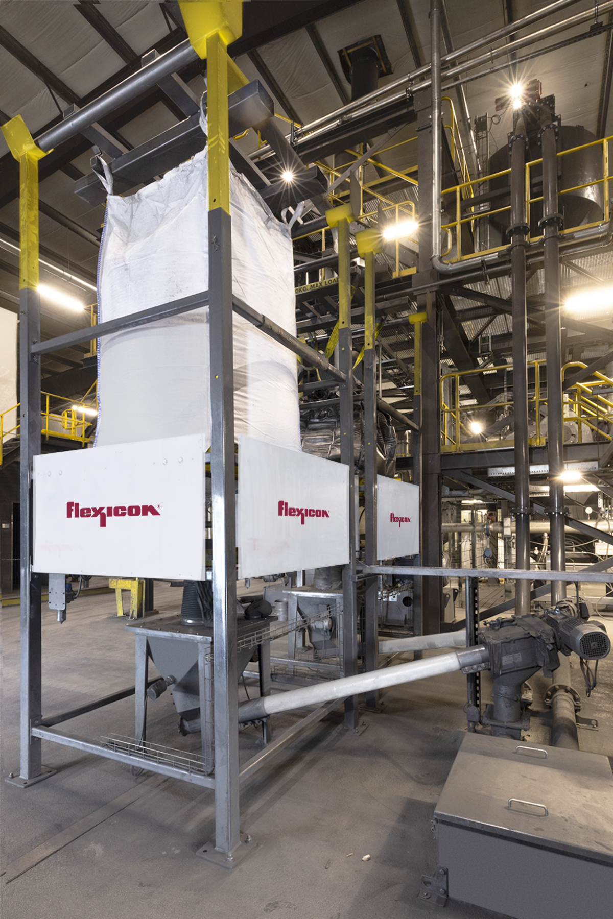 Figure 2: From hoppers beneath each bulk bag discharger, flexible screw conveyors introduce raw graphite into a tubular cable conveyor, which gently moves it to a jet mill on the mezzanine. Courtesy: Flexicon