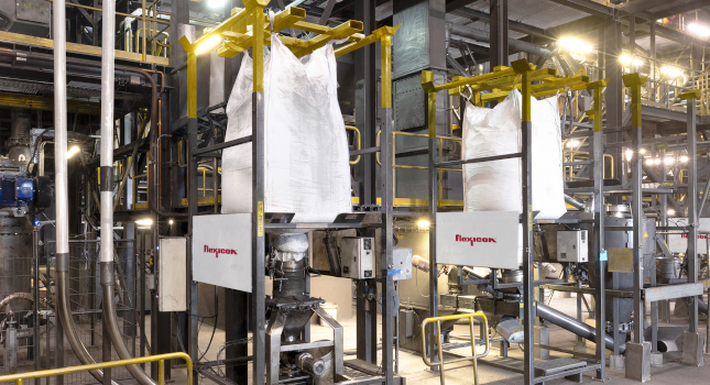Figure 1: Pairs of forklift loaded bulk bag dischargers feed raw graphite into tubular cable and flexible screw conveyors which transport it to silos and the milling process. Courtesy: Flexicon