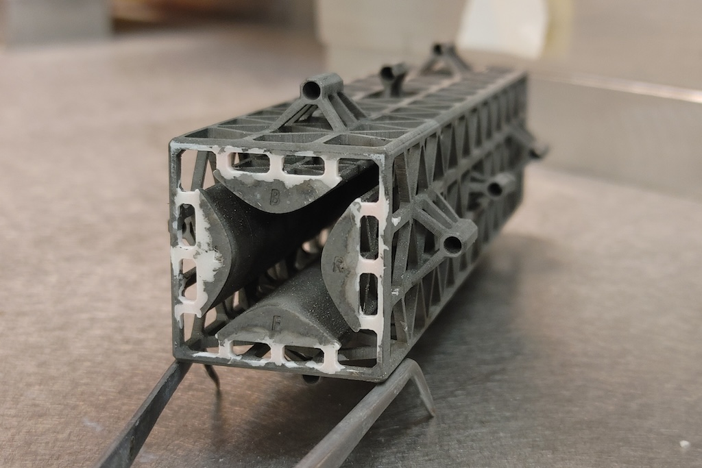 This photo shows an example of a 3D printed miniaturized quadrupole mass filter. They can be fabricated in a matter of hours for a few dollars.