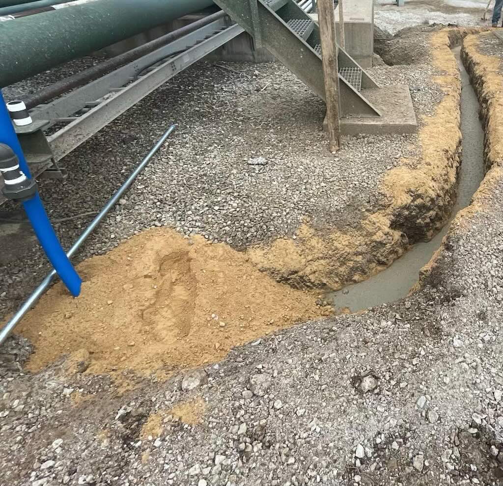 Figure 2: Semi-flexible tubing covered in concrete during the installation process.