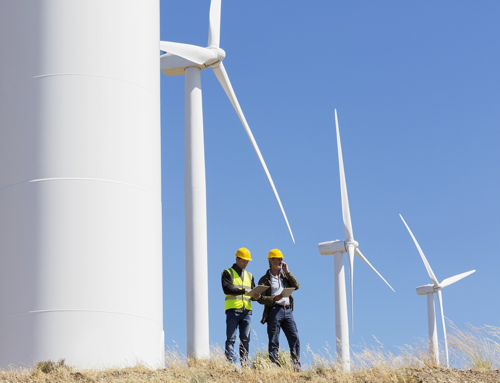 Figure 2: Maintenance workers use their mobile devices at wind turbine facility.