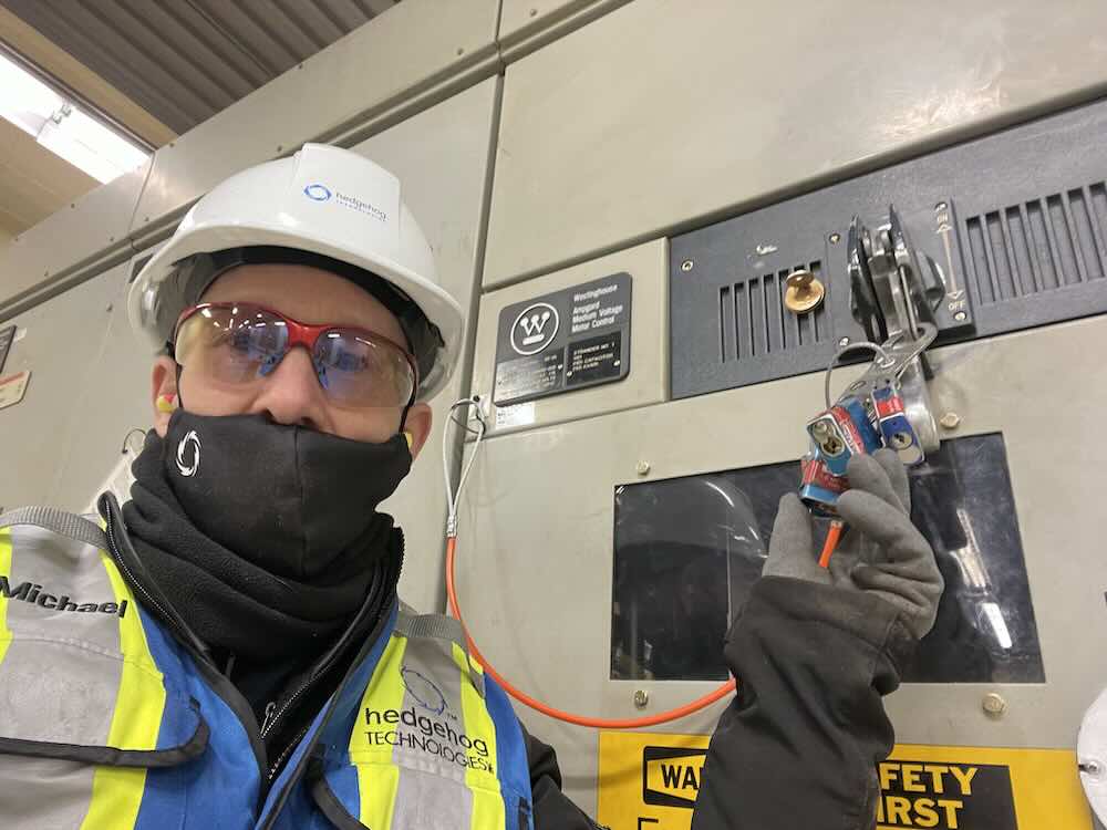 Figure 3: Engineer in front of a lockout/tag out wall. Courtesy: Hedgehog Technologies