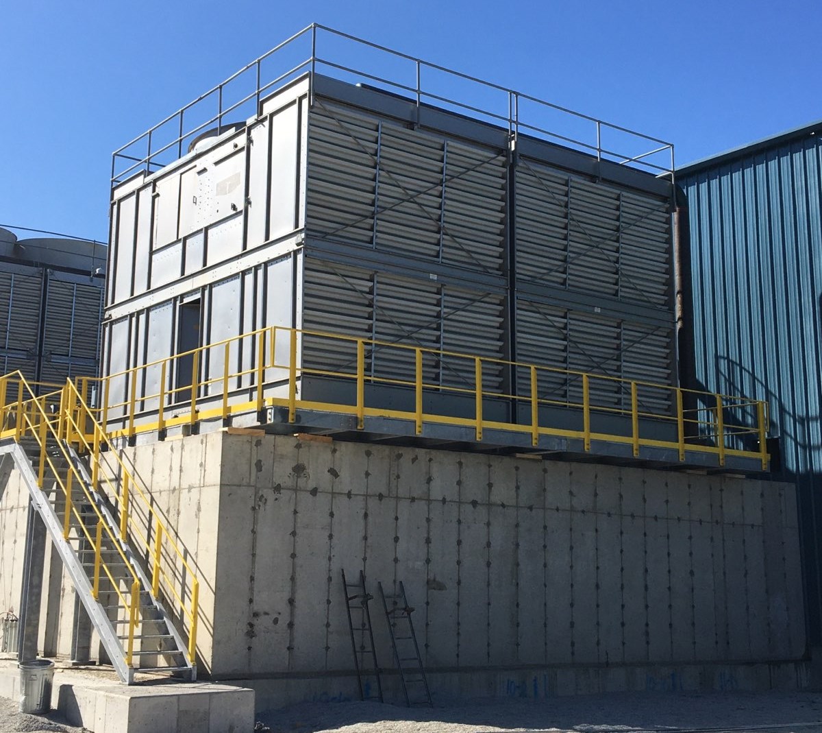 Figure 1: Cooling towers at an industrial facility, where innovative technologies are employed to minimize toxic emissions and protect the surrounding environment. Courtesy: Current Midwest