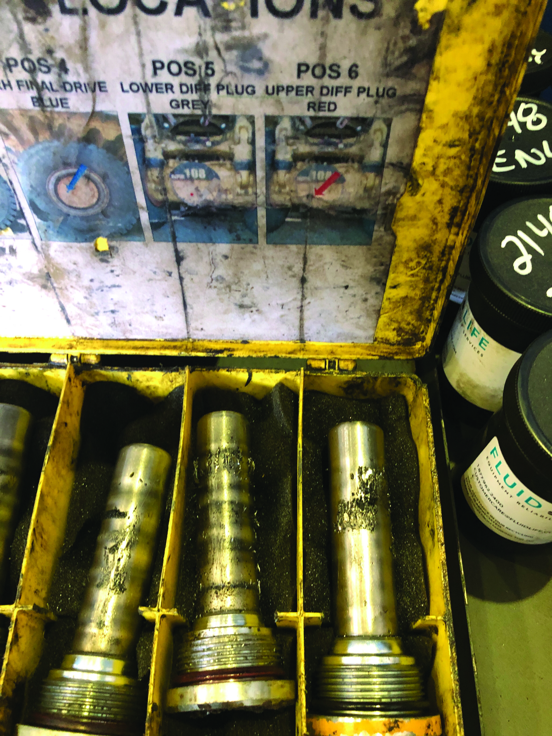Figure 2. Magnetic plugs in the oil stream of heavy, off-road vehicles capture magnetic debris for laboratory analysis. Courtesy of Jory Maccan, Imperial/STLE