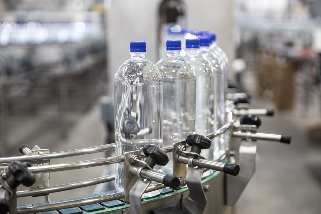 Figure 1: Inline bottling system delivering successfully capped bottles of water. Courtesy: Clarion Lubricants