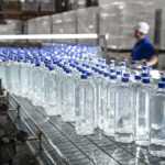 Figure 5: Inline bottling system transporting product to the final packaging stage. Courtesy: Clarion Lubricants