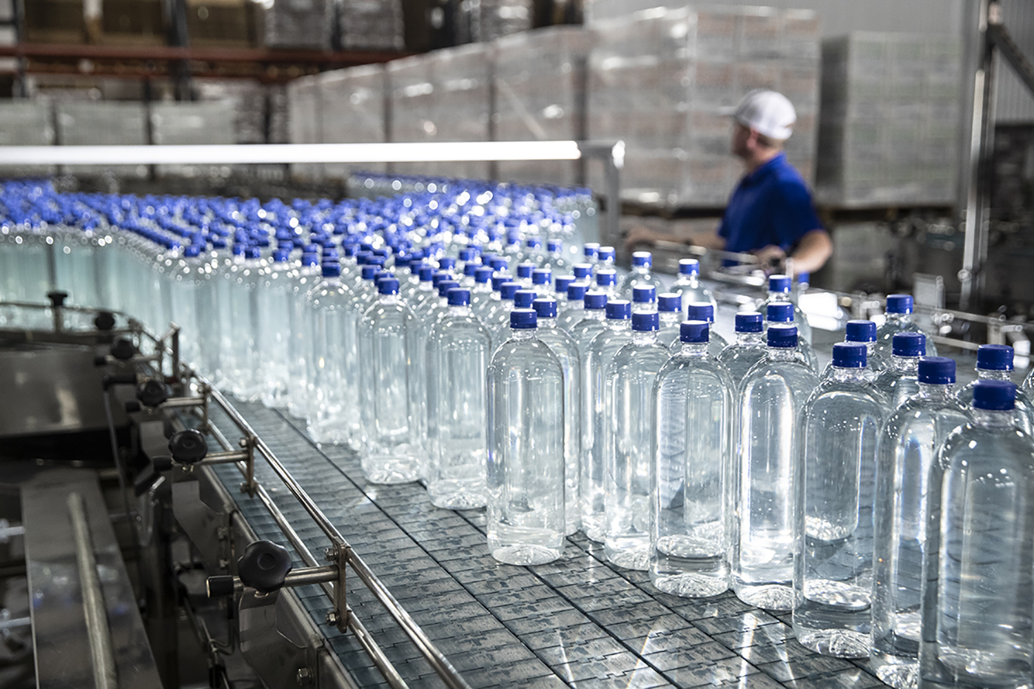 Figure 5: Inline bottling system transporting product to the final packaging stage. Courtesy: Clarion Lubricants