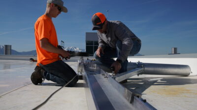 Figure 1: A worker connecting a 6-foot shock-absorbing lanyard to a certified anchorage. Courtesy: Diversified Fall Protection