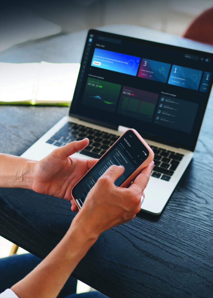 Figure 3: Operator monitoring compressor performance using SMARTLINK on both mobile and desktop devices for real-time insights and proactive maintenance. Courtesy: Atlas Copco