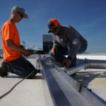 Workers performing rooftop fall protection equipment inspection. Courtesy: Diversified Fall Protection