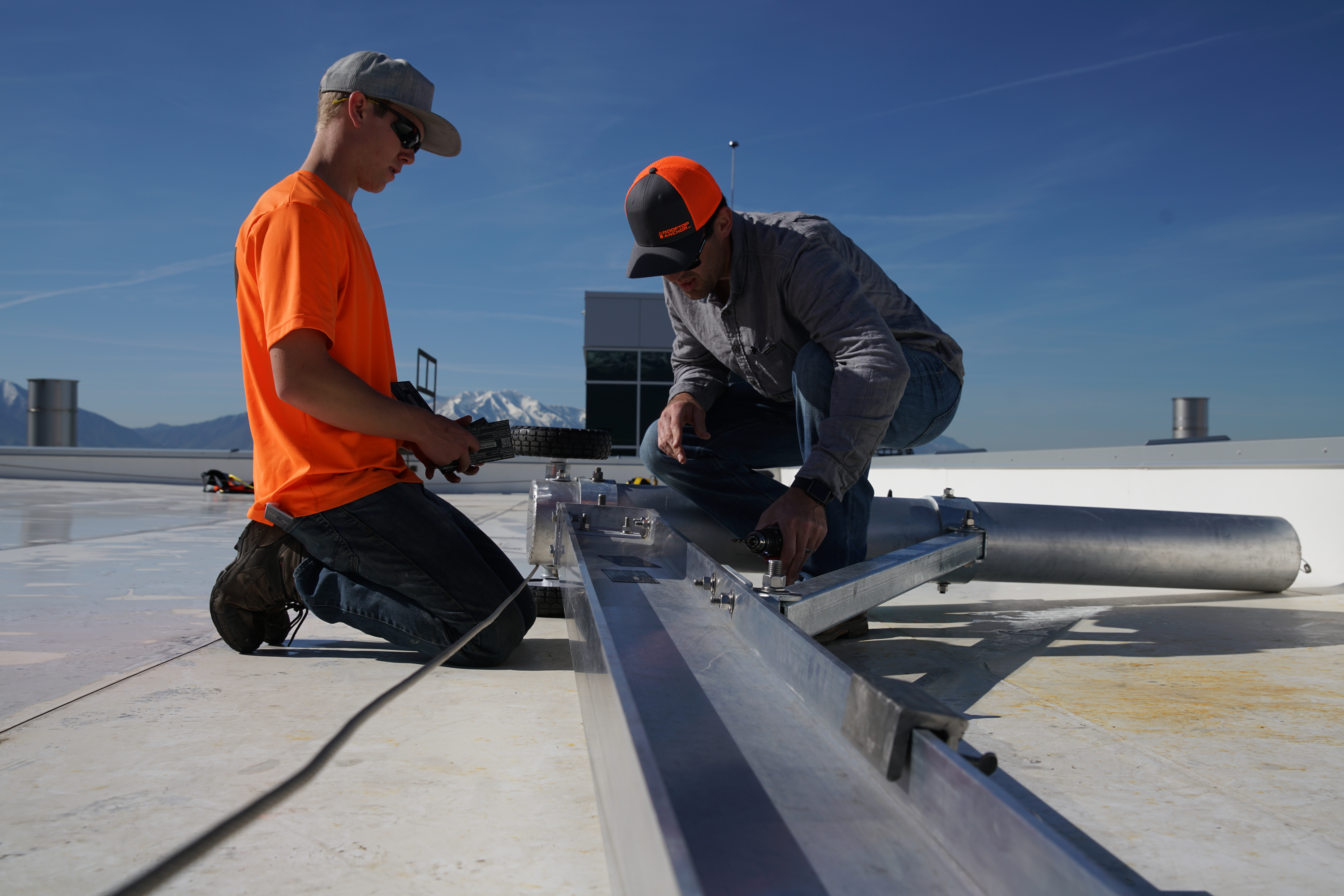 Workers performing rooftop fall protection equipment inspection. Courtesy: Diversified Fall Protection
