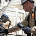 Figure 1: Operator monitors equipment with a vibration monitor to ensure the equipment is running smoothly. Courtesy: CITGO Petroleum Corp.