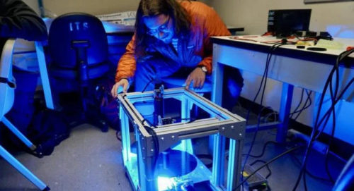 Marty LaRocque looks over the team's silicon wafer center-finding improvement device. Courtesy: Colorado University.